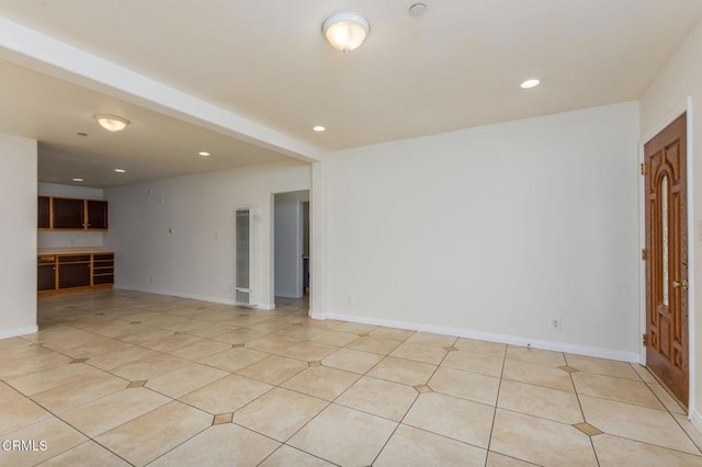 spare room with recessed lighting, a heating unit, and baseboards