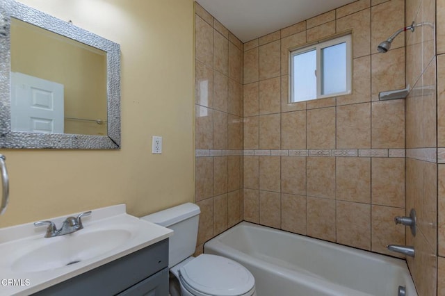 bathroom with shower / bathtub combination, toilet, and vanity