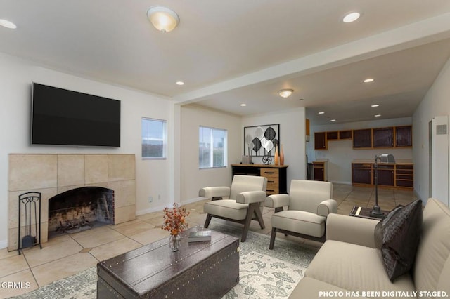 living room featuring light tile patterned floors, baseboards, recessed lighting, and a tile fireplace