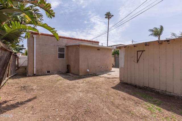 back of house featuring fence