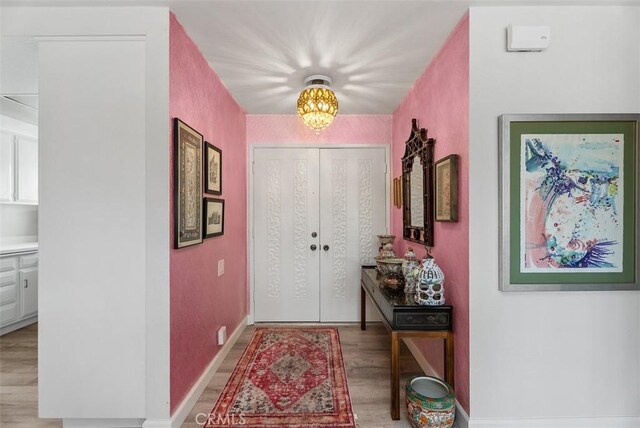 entrance foyer with light wood finished floors and baseboards