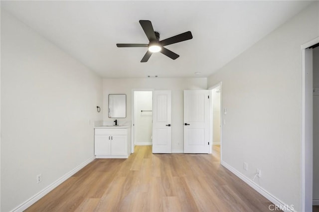 24319 Canyon Lake Dr Unit 10, Canyon Lake, CA 92587 - unfurnished bedroom featuring light wood-style flooring, a sink, visible vents, baseboards, and ceiling fan