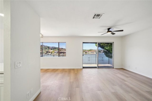 24319 Canyon Lake Dr Unit 10, Canyon Lake, CA 92587 - spare room featuring wood finished floors, visible vents, ceiling fan, and plenty of natural light
