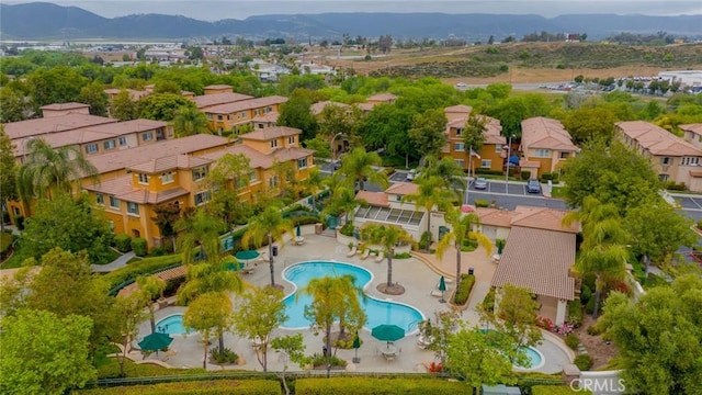 26396 Arboretum Way Unit 2906, Murrieta, CA 92563 - aerial perspective of suburban area featuring a pool and a mountain backdrop