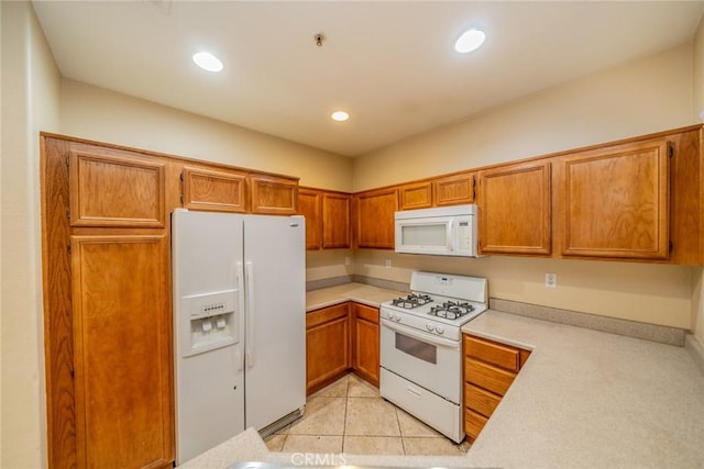 26396 Arboretum Way Unit 2906, Murrieta, CA 92563 - kitchen with white appliances, light countertops, brown cabinets, recessed lighting, and light tile patterned floors