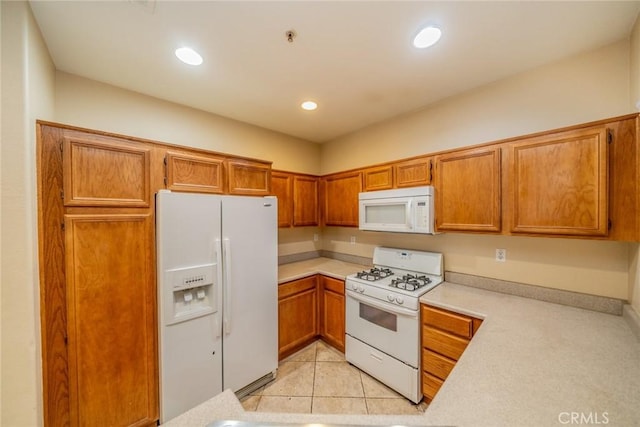 26396 Arboretum Way Unit 2906, Murrieta, CA 92563 - kitchen with white appliances, light countertops, brown cabinetry, recessed lighting, and light tile patterned flooring