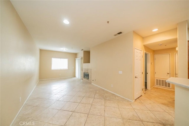 26396 Arboretum Way Unit 2906, Murrieta, CA 92563 - unfurnished living room with a tiled fireplace, light tile patterned flooring, baseboards, and recessed lighting