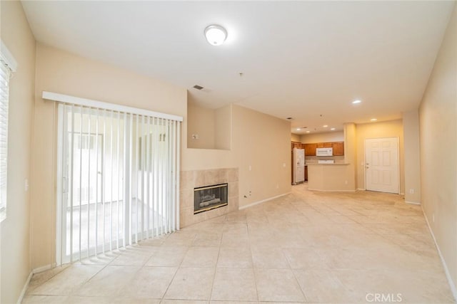 26396 Arboretum Way Unit 2906, Murrieta, CA 92563 - unfurnished living room with a tiled fireplace, baseboards, light tile patterned floors, and recessed lighting
