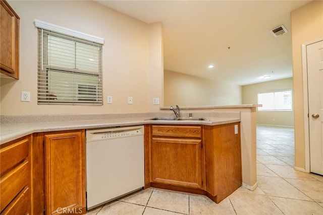 26396 Arboretum Way Unit 2906, Murrieta, CA 92563 - kitchen featuring dishwasher, light tile patterned floors, a sink, a peninsula, and brown cabinets