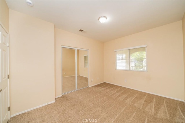 26396 Arboretum Way Unit 2906, Murrieta, CA 92563 - unfurnished bedroom with light carpet, baseboards, and a closet