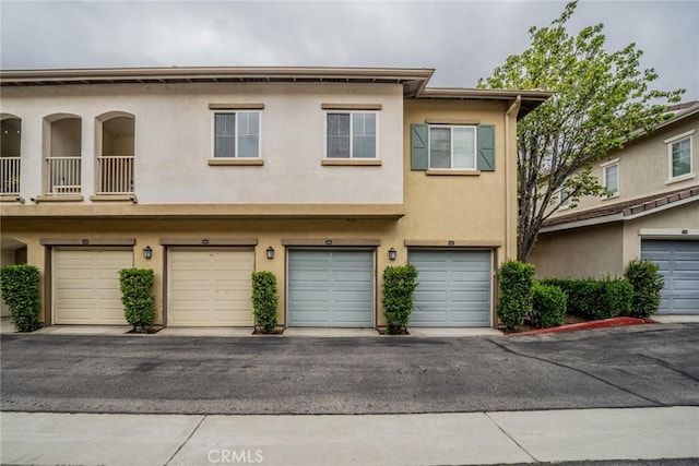 26396 Arboretum Way Unit 2906, Murrieta, CA 92563 - view of property featuring stucco siding and a garage
