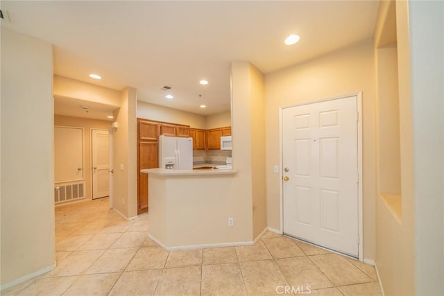 26396 Arboretum Way Unit 2906, Murrieta, CA 92563 - kitchen with white appliances, light tile patterned floors, light countertops, brown cabinets, and recessed lighting