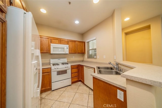 26396 Arboretum Way Unit 2906, Murrieta, CA 92563 - kitchen featuring white appliances, a sink, brown cabinets, light countertops, and a peninsula