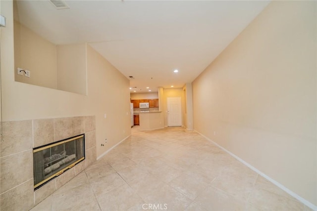 26396 Arboretum Way Unit 2906, Murrieta, CA 92563 - unfurnished living room featuring a tile fireplace, recessed lighting, baseboards, and light tile patterned floors