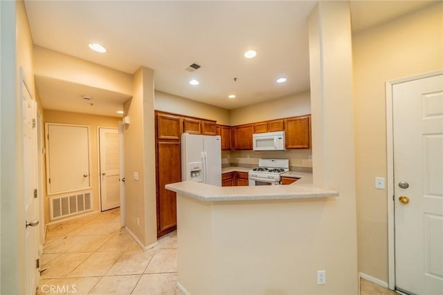 26396 Arboretum Way Unit 2906, Murrieta, CA 92563 - kitchen featuring white appliances, brown cabinetry, light countertops, light tile patterned floors, and a peninsula