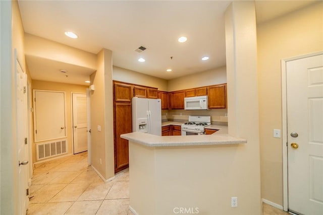 26396 Arboretum Way Unit 2906, Murrieta, CA 92563 - kitchen with white appliances, brown cabinetry, light countertops, light tile patterned floors, and a peninsula