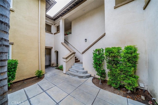 26396 Arboretum Way Unit 2906, Murrieta, CA 92563 - view of exterior entry with stucco siding and a patio area