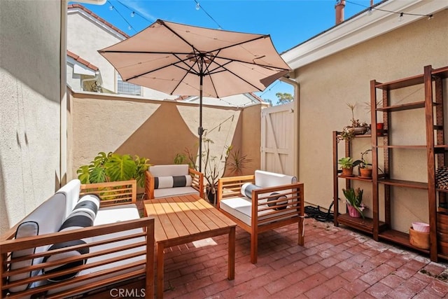 view of patio with outdoor lounge area and fence
