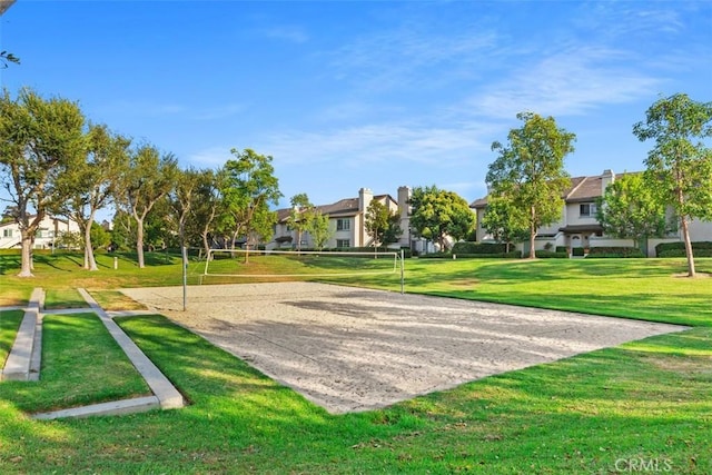 view of property's community with a yard, a residential view, and volleyball court
