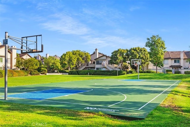view of sport court with a lawn, community basketball court, and a residential view