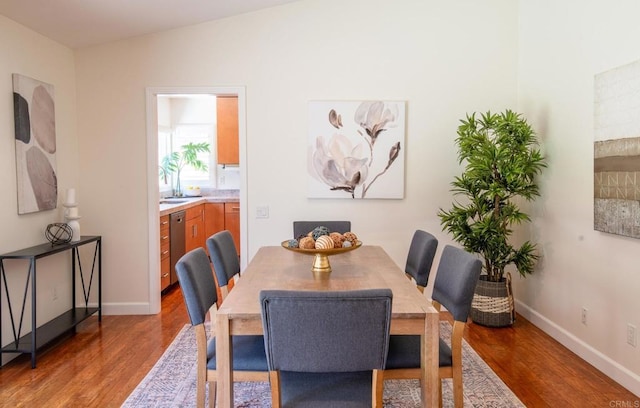 dining space featuring wood finished floors and baseboards