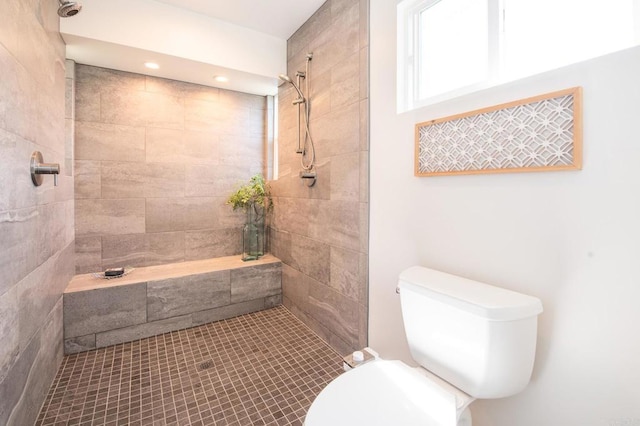 bathroom with toilet and tiled shower
