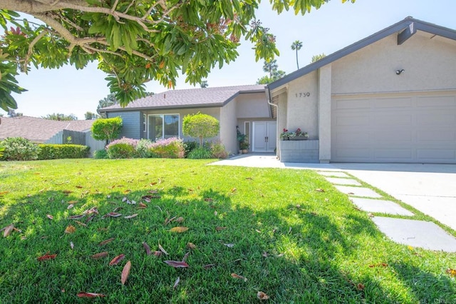 single story home with stucco siding, a front yard, a garage, and driveway