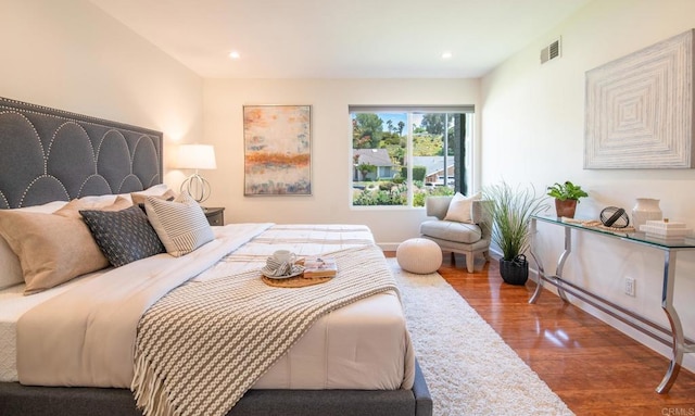 bedroom featuring wood finished floors and recessed lighting