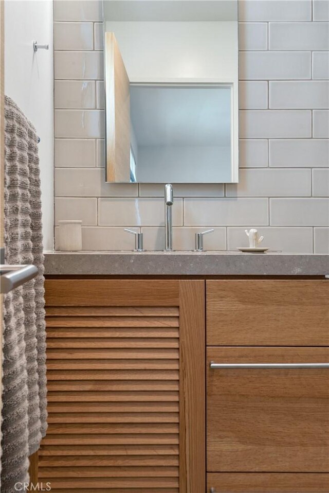 interior space with a sink and tasteful backsplash