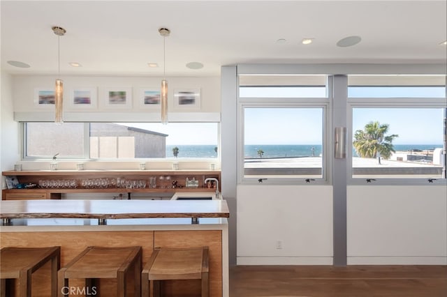 kitchen with a water view and decorative light fixtures