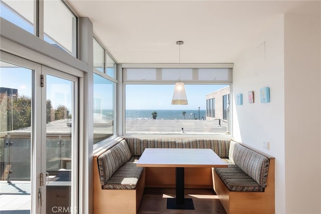 sunroom / solarium with a water view and a wealth of natural light