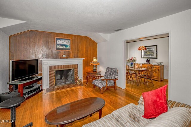 1404 Sycamore Ave, Glendale, CA 91201 - living area featuring wood finished floors, a brick fireplace, and wooden walls