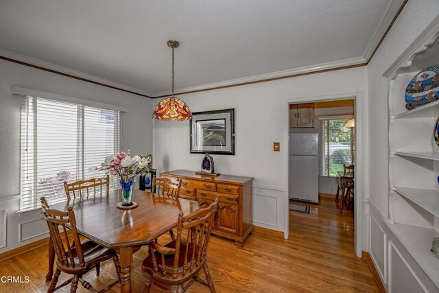 1404 Sycamore Ave, Glendale, CA 91201 - dining space with ornamental molding, light wood finished floors, wainscoting, and a decorative wall