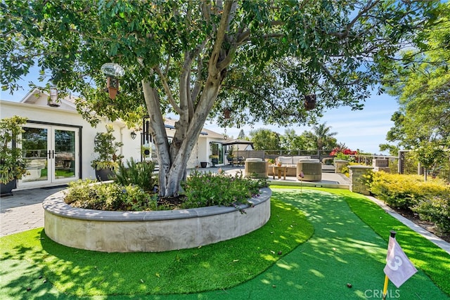 view of yard with a patio area, outdoor lounge area, and french doors