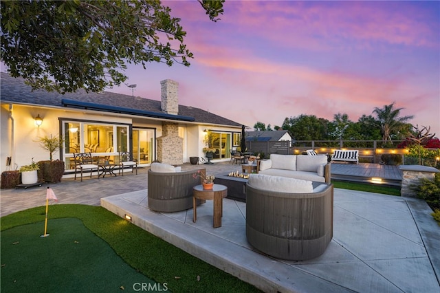 patio terrace at dusk with an outdoor hangout area