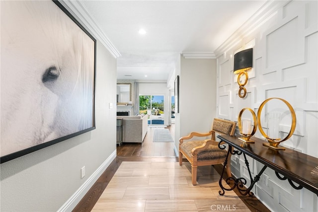 hall with baseboards, ornamental molding, and recessed lighting