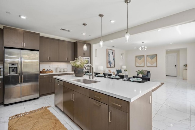 6784 Kenmar Way, San Diego, CA 92130 - kitchen featuring stainless steel appliances, light marble finish flooring, recessed lighting, light countertops, and dark brown cabinets