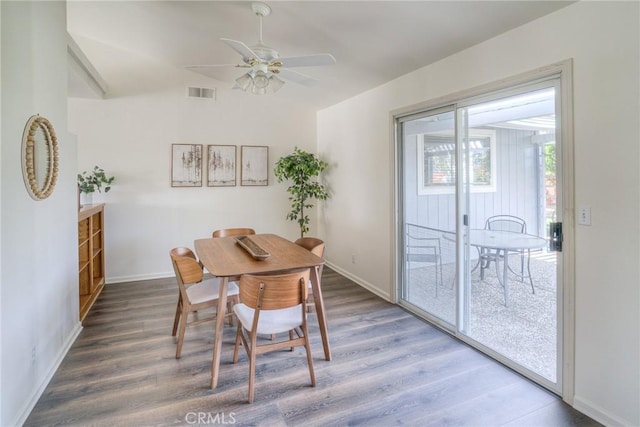 dining space with wood finished floors, visible vents, baseboards, and ceiling fan