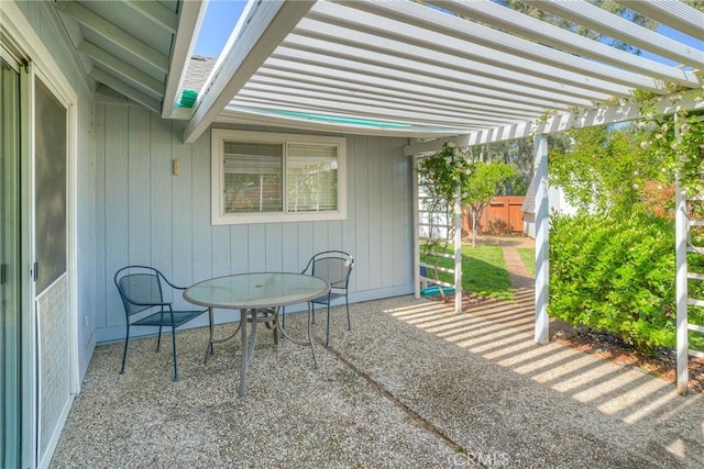 view of patio / terrace with a pergola and fence