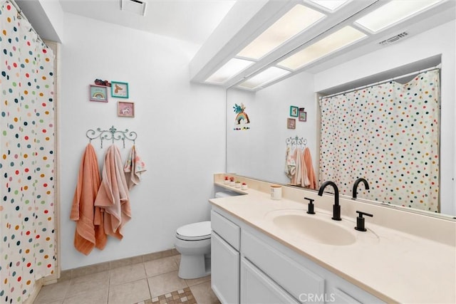 bathroom featuring visible vents, baseboards, toilet, tile patterned floors, and vanity