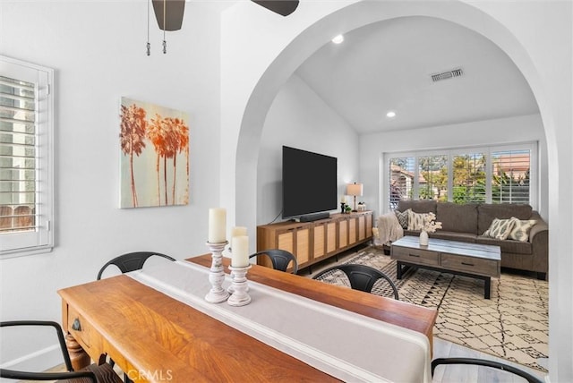 living area with recessed lighting, a ceiling fan, visible vents, vaulted ceiling, and arched walkways