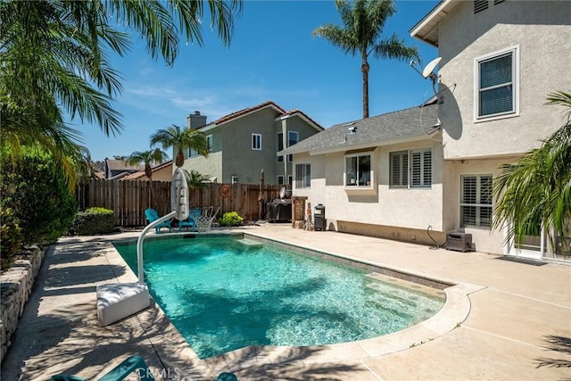 view of pool featuring fence, a fenced in pool, and a patio area