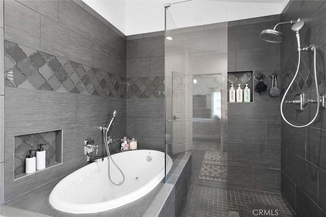 full bath with a tile shower and a whirlpool tub