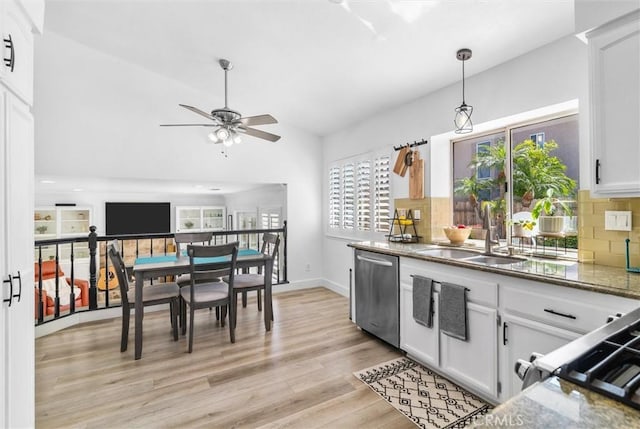kitchen with a sink, decorative backsplash, light wood-style floors, ceiling fan, and stainless steel dishwasher