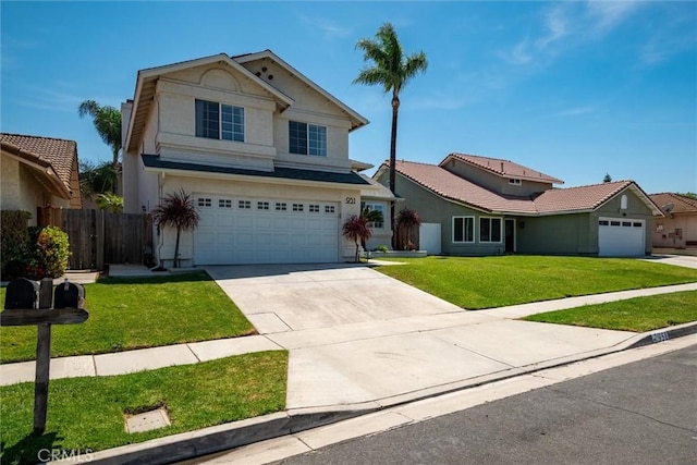 traditional-style house featuring stucco siding, fence, a garage, a front lawn, and concrete driveway