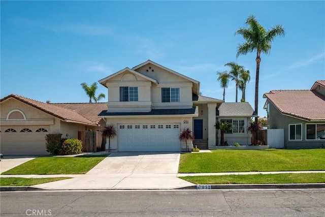 view of front of property with stucco siding, fence, driveway, a front yard, and an attached garage