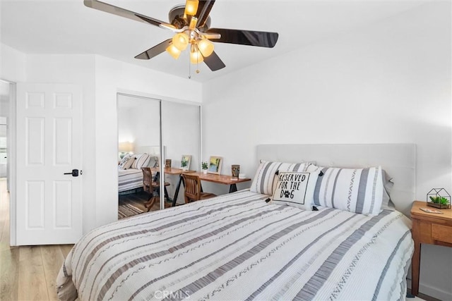 bedroom featuring wood finished floors, a ceiling fan, and a closet