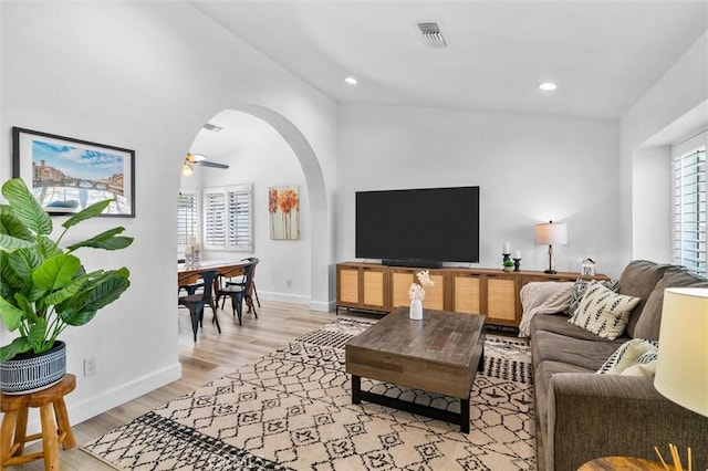 living room with visible vents, baseboards, light wood-style floors, and a healthy amount of sunlight