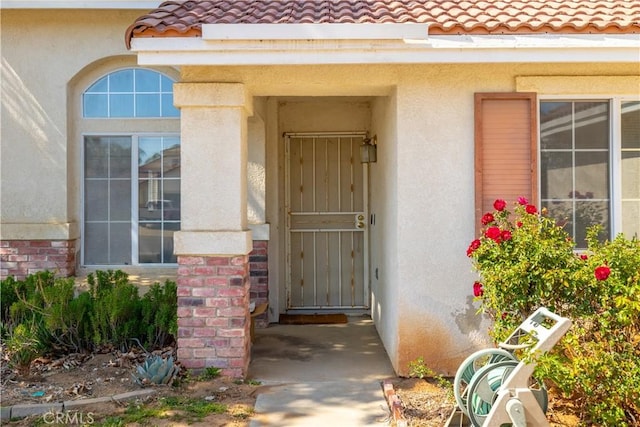 25714 Sunnyvale Ct, Menifee, CA 92584 - property entrance featuring stucco siding and a tiled roof