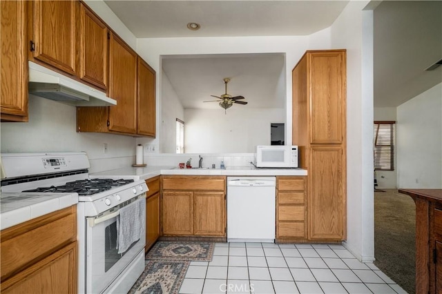 25714 Sunnyvale Ct, Menifee, CA 92584 - kitchen featuring ceiling fan, a sink, white appliances, tile counters, and under cabinet range hood